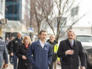 Vancouver City Manager Eric Holmes, right, walks with U.S. Department of Transportation Secretary Pete Buttigieg, center, during a Feb. 13 tour of the Vancouver waterfront.