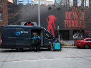 An Amazon prime delivery van parks Feb. 23, 2023, in front the Devil's Triangle near the Amazon Campus in South Lake Union, Seattle.