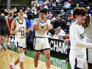 Seton Catholic's Rico George, left, and Lance Lee celebrate after a 49-40 win over Riverside in a Class 1A boys basketball consolation round game on Friday, March 1, 2024 in Yakima.