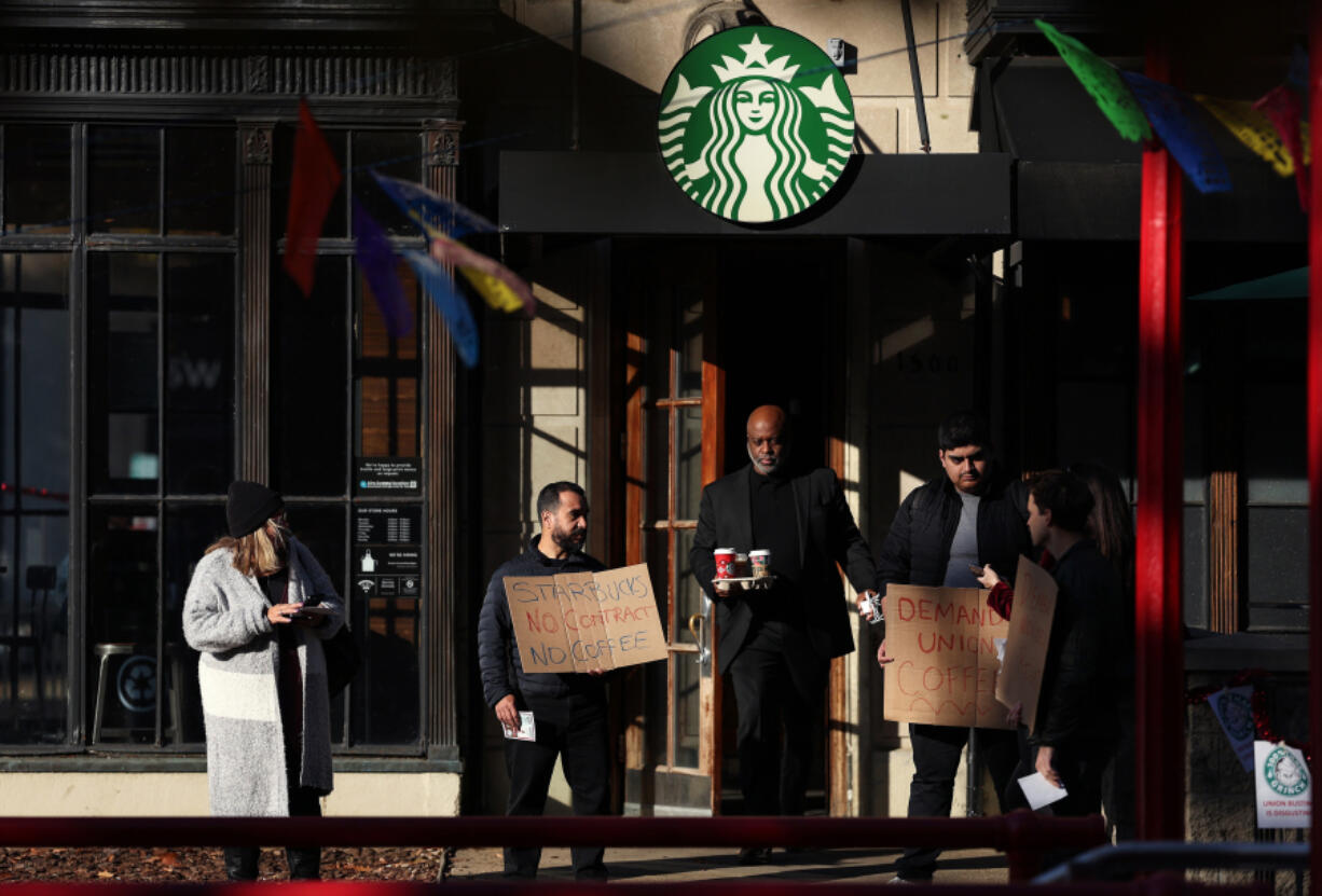Members and supporters of Starbucks Workers United protest outside of a Starbucks store in Dupont Circle on Nov. 16, 2023, in Washington, D.C. The group held a series of rallies on Starbuck&rsquo;s promotional &ldquo;Red Cup Day&rdquo; outside of non-union Starbucks stores to demand Starbucks respect union rights.