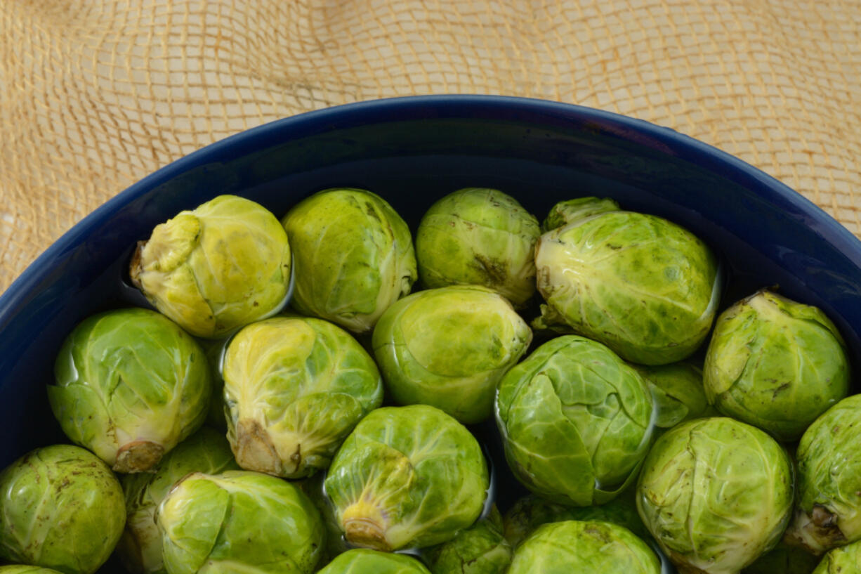 Preheat oven to 400 
 &deg;F. Remove stem end from Brussel sprouts and cut in half. Cut potatoes in half or into pieces about the same size as the Brussel sprouts. Line a baking sheet with foil. Add the oil and roll the potatoes and Brussel sprouts in the oil making sure all sides are covered. (Dorothy Merrimon Crawford/Dreamstime/TNS)