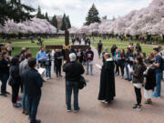 Members of the Prince of Peace Catholic Newman Center at University of Washington pray at The Quad on Good Friday in March 2018 in Seattle.