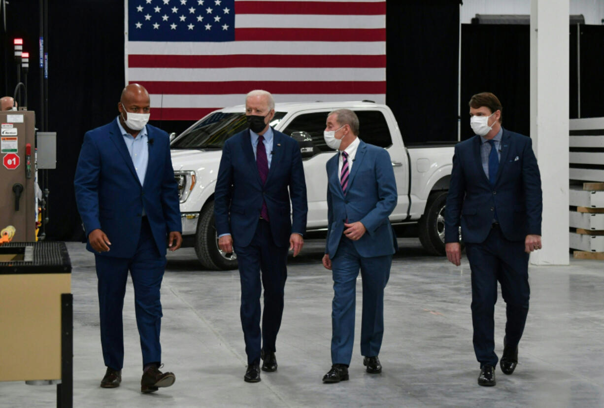 President Joe Biden with Corey Williams, left, plant manager, William Ford, Jr., second from left, executive chairman of Ford Motor Company, and Jim Farley, right, CEO of Ford Motor Company, tours the Ford Rouge Electric Vehicle Center in Dearborn, Michigan, on May 18, 2021.