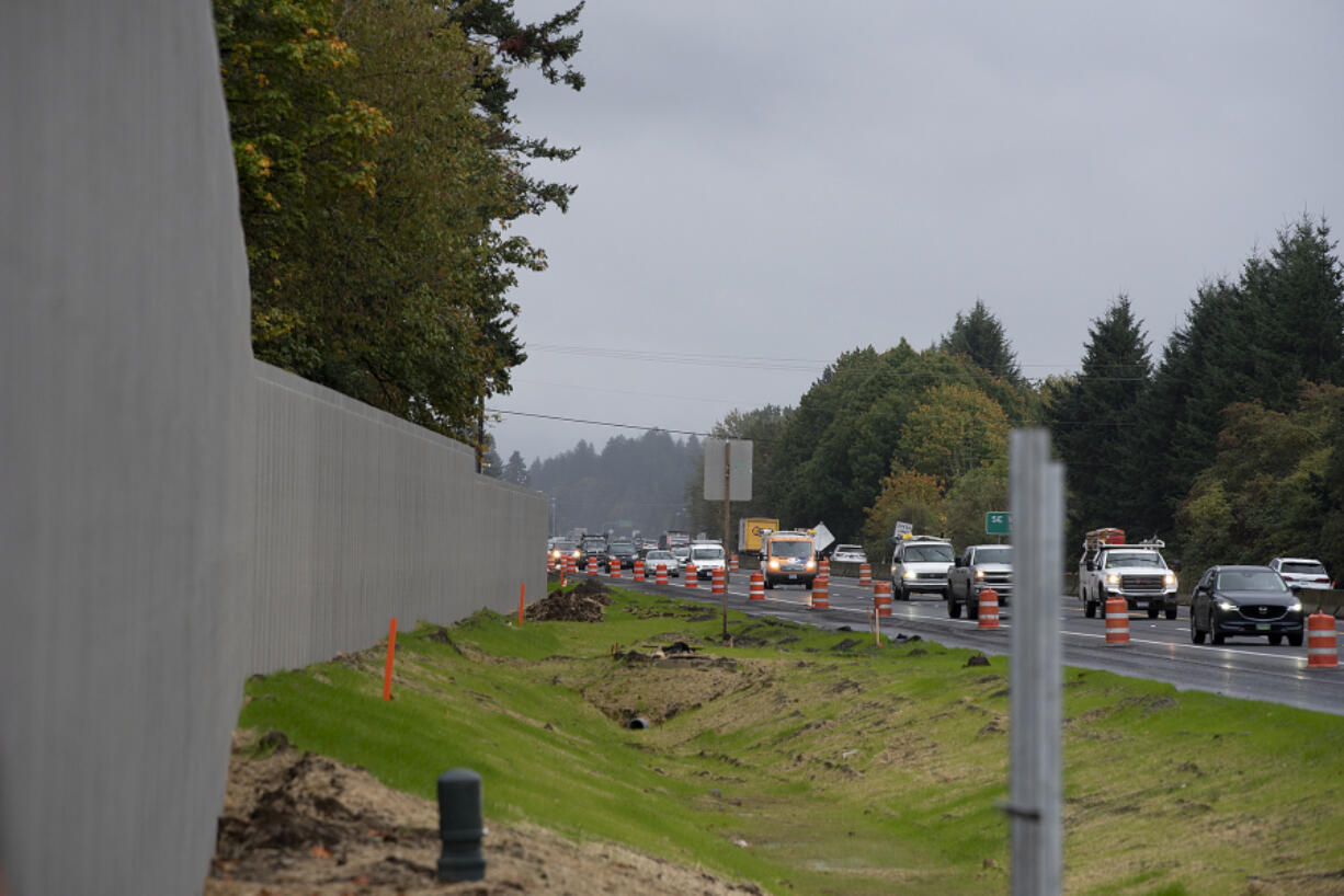 Traffic travels westbound on state Highway 14 while passing a nearly completed sound wall on Oct. 25, 2023.