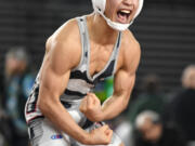 Union junior Noah Koyama flexes after winning the 4A 138-pound championship Saturday, Feb. 17, 2024, during the Mat Classic state wrestling tournament at Tacoma Dome.
