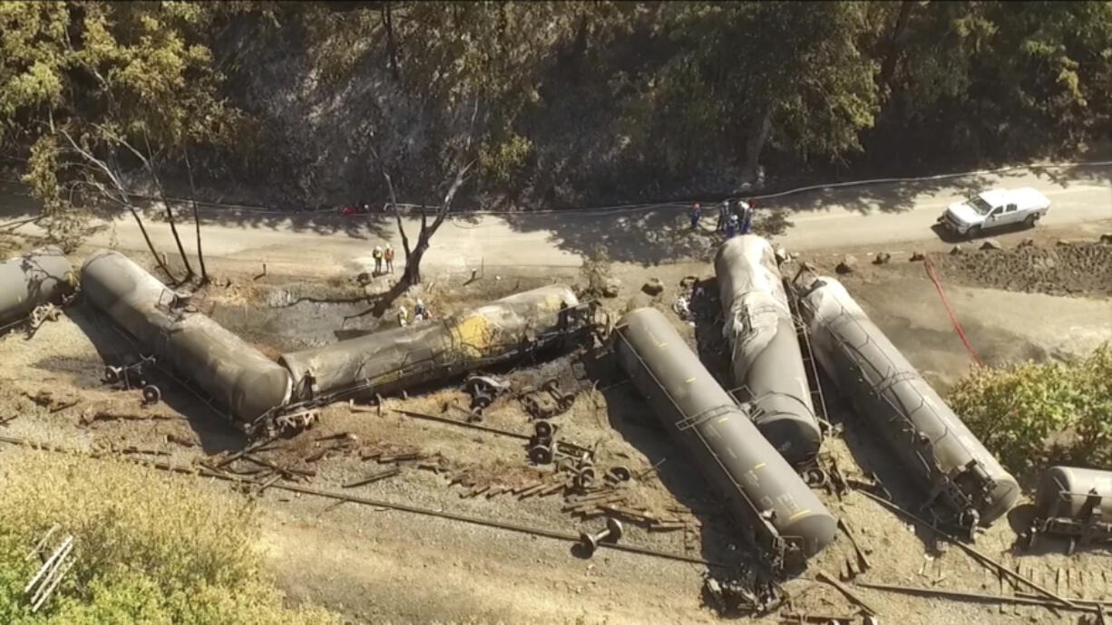 Crumpled oil tankers lie beside the railroad tracks June 6, 2016, after a fiery train derailment that prompted evacuations from the tiny Columbia River Gorge town of Mosier, Ore.