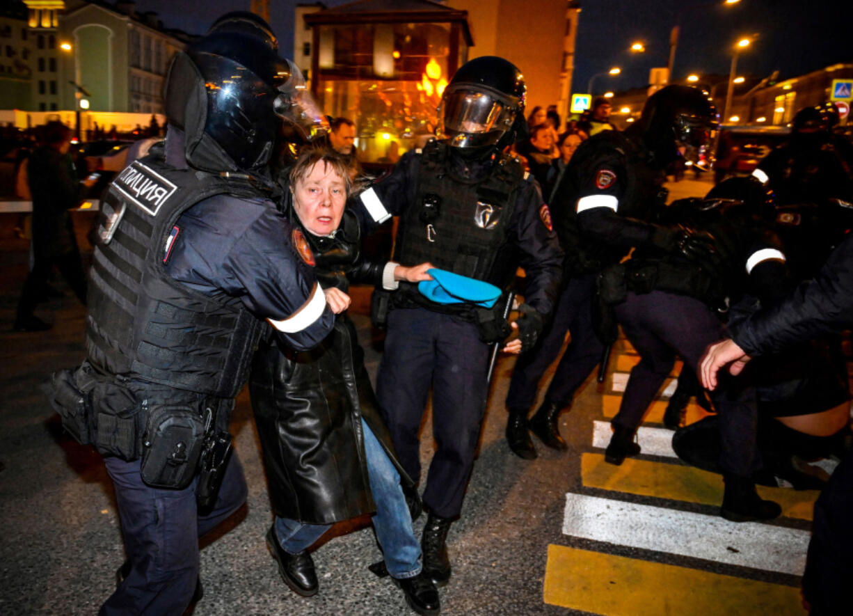 Police officers detain a woman Sept. 21, 2022, following calls to protest against the partial mobilization announced by the Russian president in Moscow.