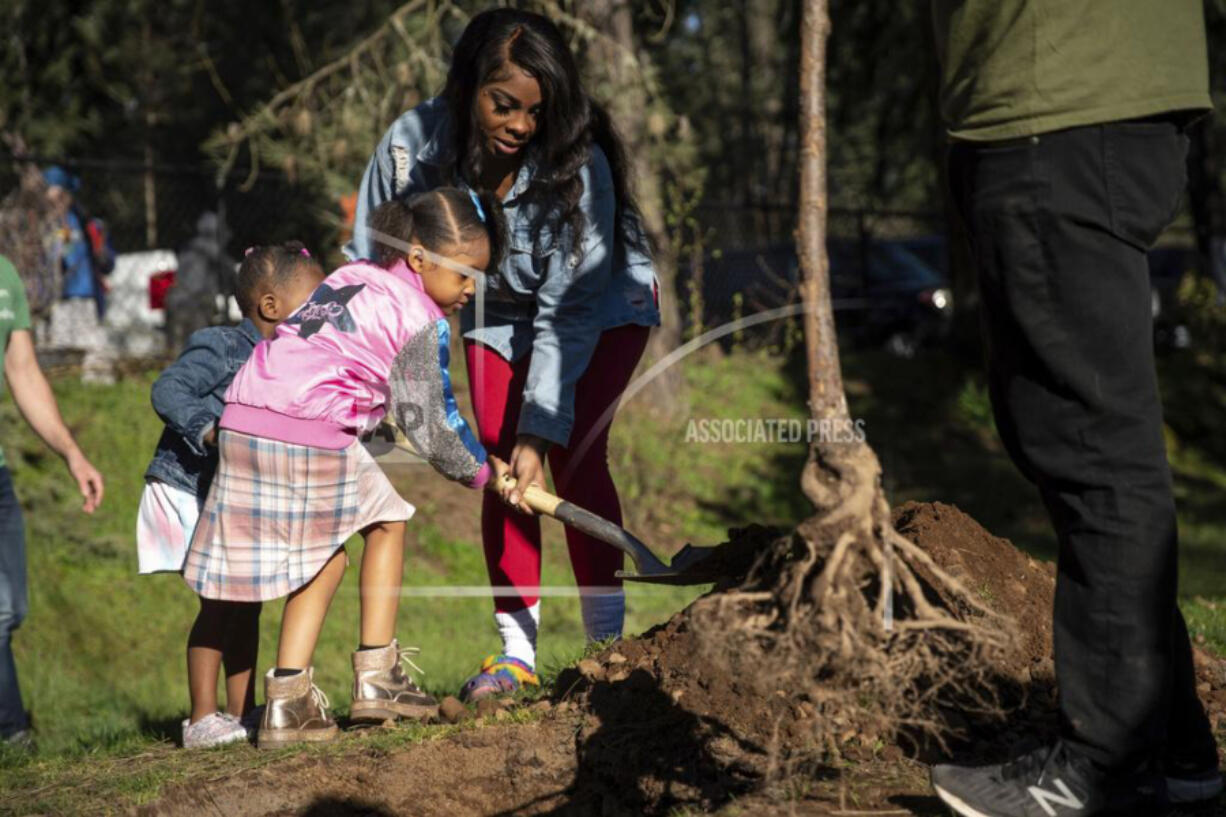 Dozens gathered at Nadaka Nature Park in Gresham, Ore., Saturday to plant trees in memory of those who died during the heatwave of 2021.