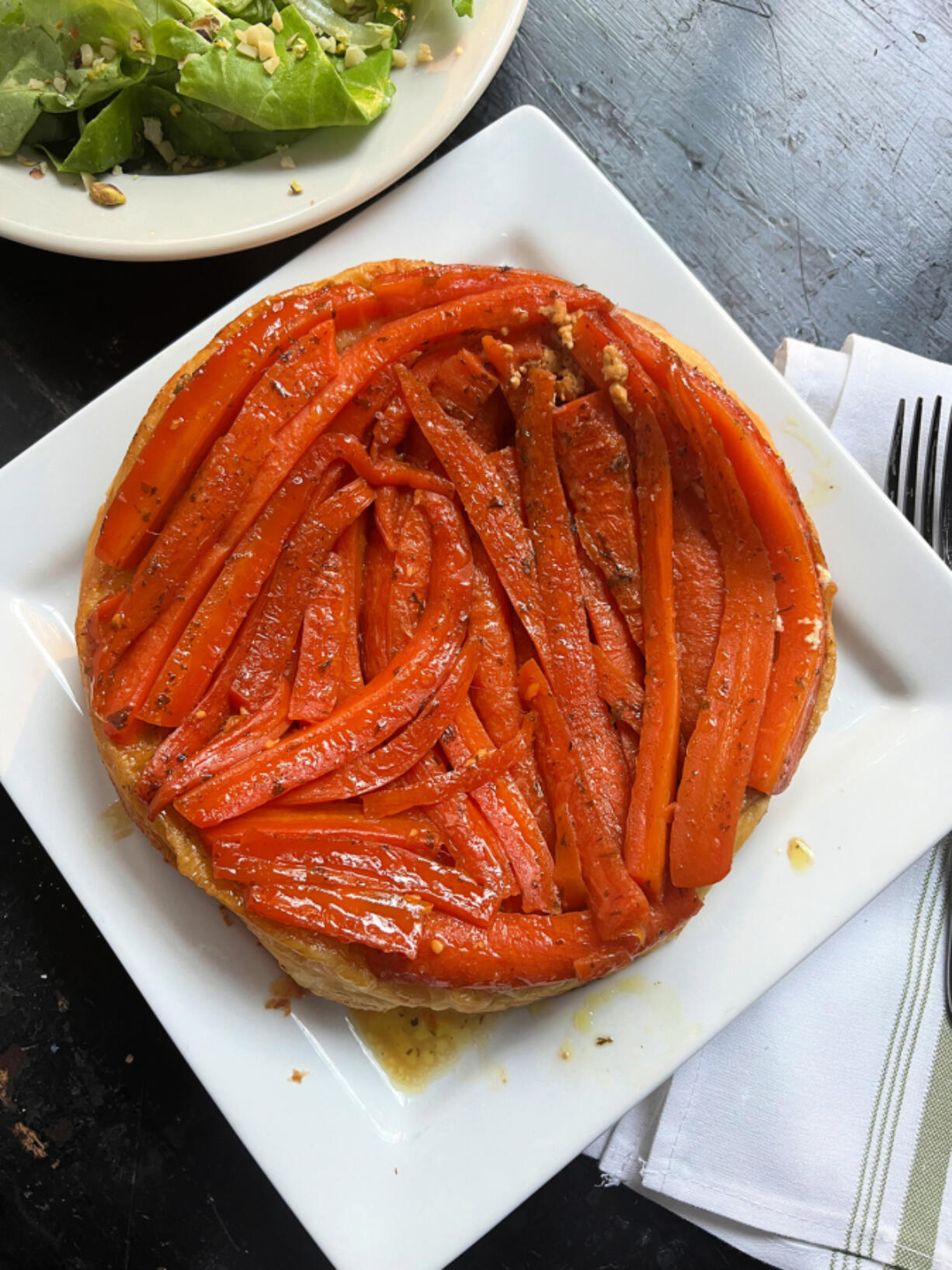 A savory carrot tarte tatin is paired with a green salad for a simple, and elegant, vegetarian supper.