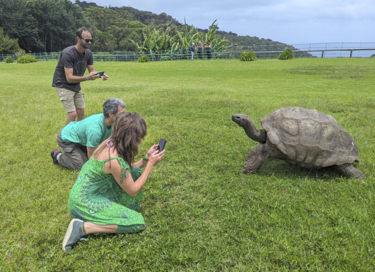 Tourists take photos Feb. 22 of Jonathan, a 192-year-old tortoise, on the lawn of Plantation House on the South Atlantic island of St. Helena.