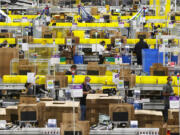 Employees at packing stations are seen at Amazon&rsquo;s Kent, Washington, fulfillment center on June 11, 2020. Amazon says 2023 data points to a year of &ldquo;meaningful, measurable progress&rdquo; but two advocacy groups say the company&rsquo;s numbers don&rsquo;t tell the full story.