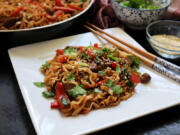 Chinese egg noodles tossed in a spicy sauce with lamb and spring vegetables is a fast and easy weeknight meal.