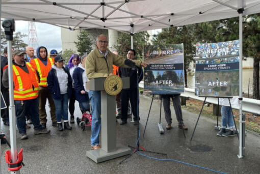Gov. Jay Inslee points to the work his homeless encampment initiative has done to clear encampments and transition people into housing. Inslee released his budget proposals surrounding housing and homelessness programs at the site of a former encampment in Seattle.