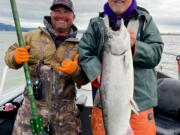 Guide Austin Moser, (left), and Buzz Ramsey with a nice lower Columbia River spring Chinook. The season for spring Chinook retention on the Columbia will close after April 5.