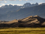 The Great Sand Dunes are lit by the setting sun near Mosca, Colo. (Helen H.