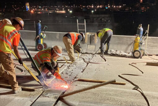 Workers cut away an old expansion joint on Interstate 5 in Seattle, during 2022.