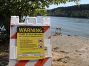 A sign warns visitors of a toxic algal bloom at Lacamas Lake in Camas in July 2020.