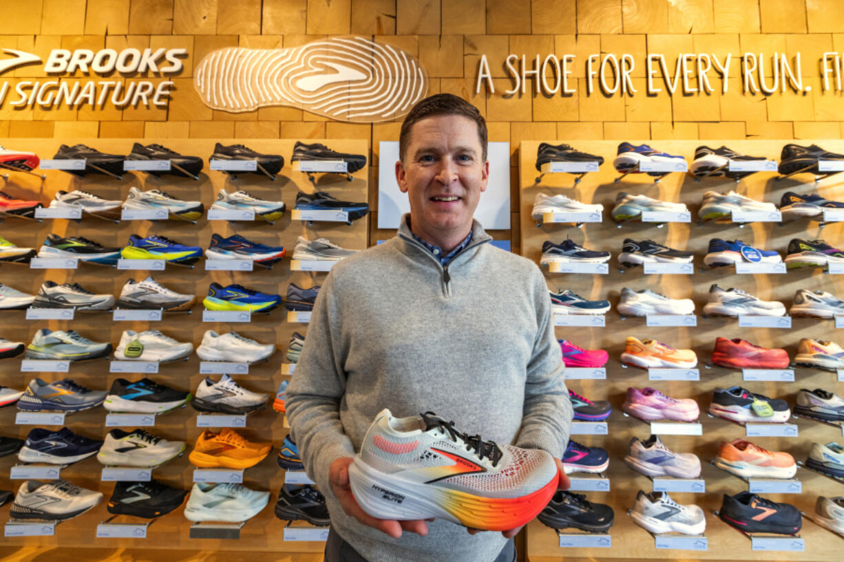 Dan Sheridan, upcoming Brooks Running CEO, is seen at the shoe wall in the the Fremont store, Tuesday, March 12, 2024, in Seattle.