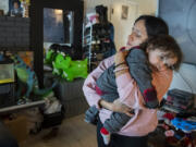 Monica Zazueta, 37, of Vancouver comforts her toddler, Rufio,1, after he took a tumble on the floor at their home Feb. 15. Zazueta and her family, who experienced homelessness a few years ago, are now housed and paying rent of almost $1,900 a month. She fears the family will become homeless again. &ldquo;We&rsquo;re surviving through love,&rdquo; she said. &ldquo;Our kiddos don&rsquo;t deserve this kind of life.