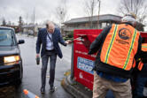 Clark County Auditor Greg Kimsey, left, helps a voter drop off their ballot at the box in downtown Vancouver on Tuesday morning. &ldquo;A cynic once described Washington&rsquo;s presidential primary as a state-funded voter identification project for the two major political parties,&rdquo; he said.