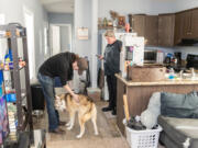Charley Jewell, left, pets dog Hugo while his mom Casey Jewell waits for a call from her lawyer Wednesday at their new home in Vancouver. Casey Jewell previously lived in a nearby mobile home that had a hole in the ceiling and a host of other issues.