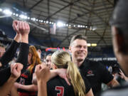 Camas head girls basketball coach Scott Thompson, right, hugs Camas senior Riley Sanz (3) on Saturday, March 2, 2024, after the Papermakers&Ccedil;&fnof;&Ugrave; 57-41 win against Gonzaga Prep in the 4A WIAA State Basketball championship game at the Tacoma Dome.