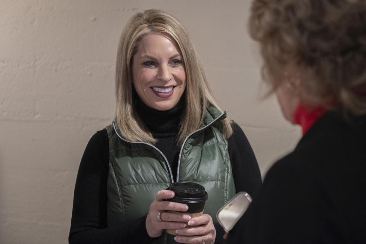 Leslie Lewallen, center, who is running as a Republican to represent the 3rd Congressional District, talks with supporters at her campaign headquarters in Camas on Friday afternoon.