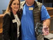 Ridgefield Chamber of Commerce President Dawn Bell presents the Community Champions Award to Ridgefield Lions President Josh Olson.
