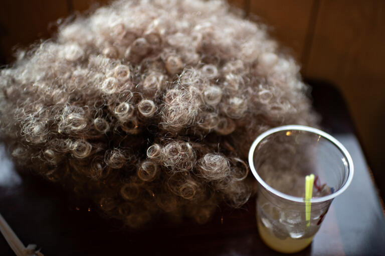 A discarded wig and an empty drink are seen at Happy Family Restaurant as the night winds down during the Mrs. Roper Pub Crawl in downtown Battle Ground on Saturday evening, March 23, 2024.
