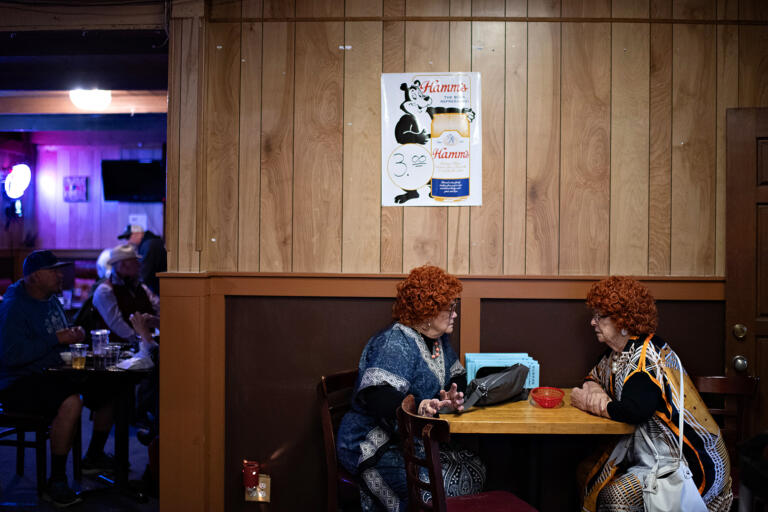 Carol DeBruyne of Vancouver, left, chats with Lee Humphrey of Battle Ground at Happy Family Restaurant while enjoying the Mrs. Roper Pub Crawl in downtown Battle Ground on Saturday evening, March 23, 2024.