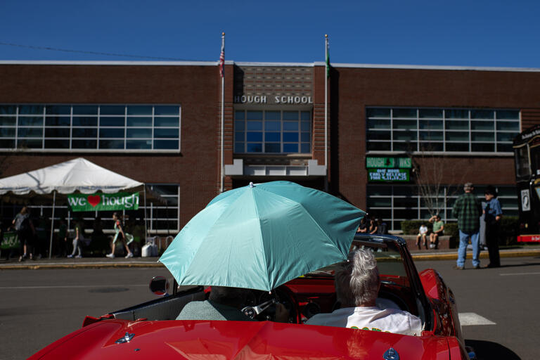Parade participants bring their own shade as they relax in their car before the start of the annual Paddy Hough Parade on Friday afternoon, March 15, 2024.
