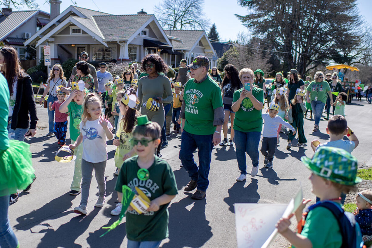 Participants of all ages greet spectators along the route of the annual Paddy Hough Parade on Friday afternoon, March 15, 2024.