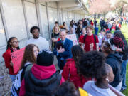 Vancouver Public Schools superintendent Jeff Snell, center, talks to Fort Vancouver High School students on Tuesday during the students&rsquo; walk-out to protest the district&rsquo;s cuts to 262 staff positions next year.