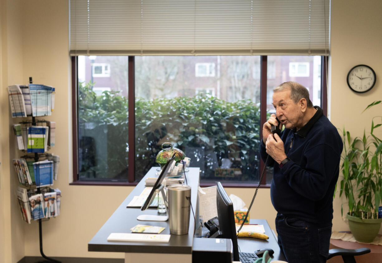 Longtime volunteer John LaPointe answers the front desk phone Monday at the NAMI Southwest Washington office in Vancouver.