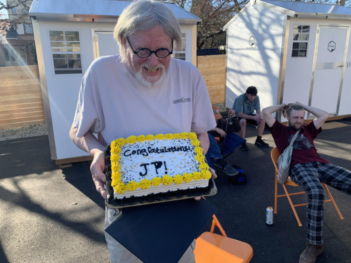 Jp Walmer receives a cake on his last day at 415 West, the downtown Vancouver transitional housing pod for people experiencing homelessness.