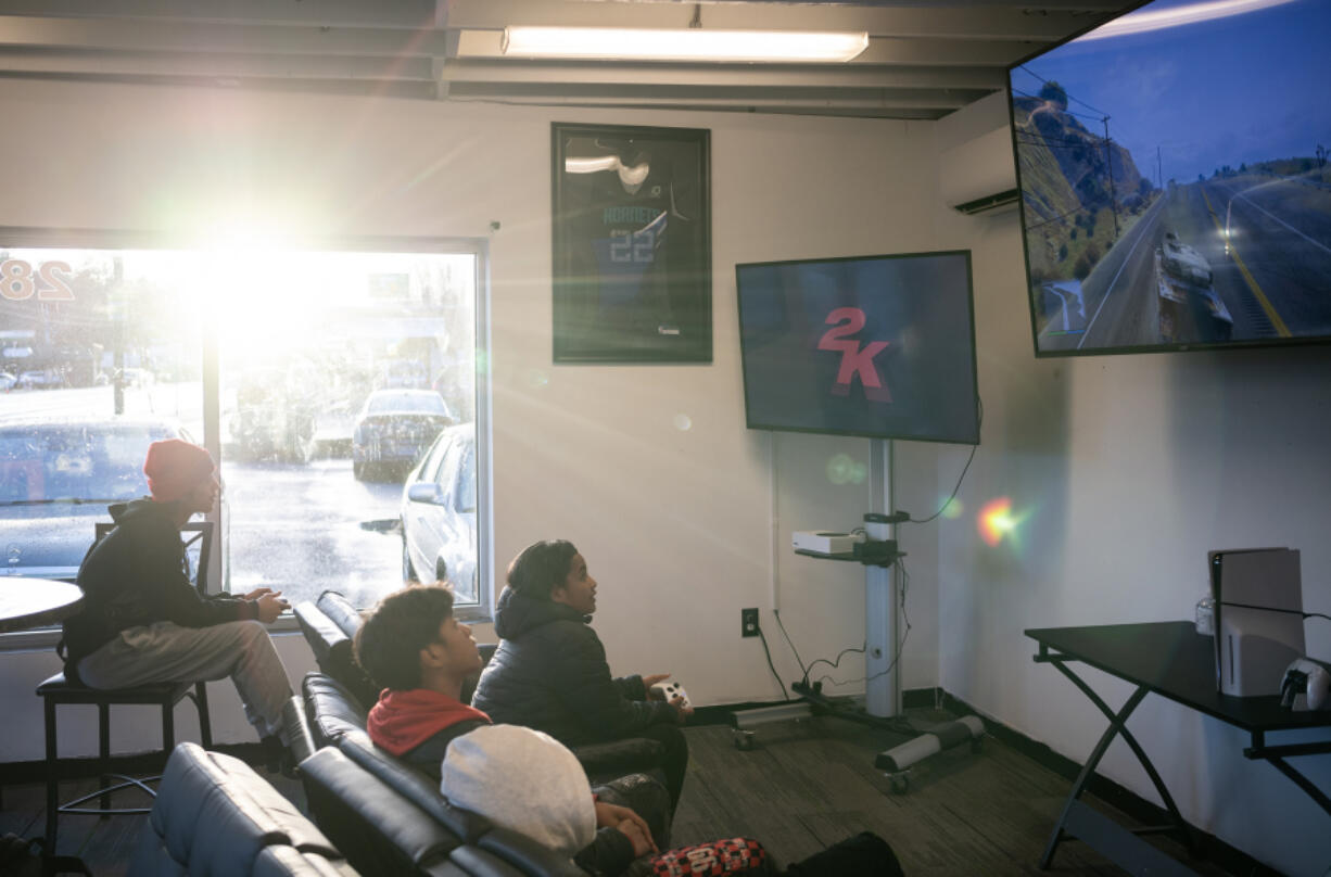 Teens play video games after an Insight to Foresight class Wednesday at The Foundation nonprofit in Vancouver.