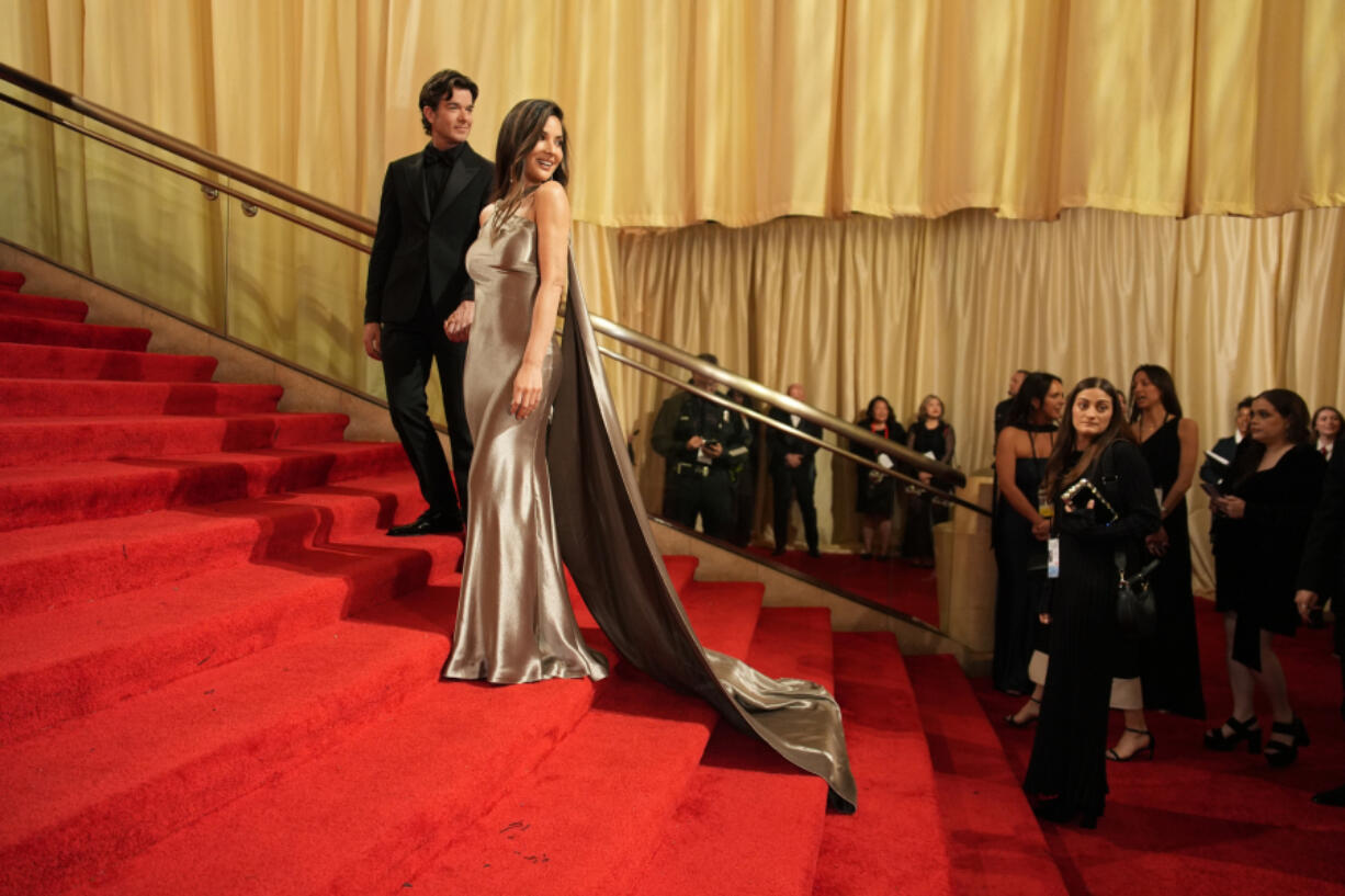 John Mulaney, left, and Olivia Munn arrive at the Oscars, Sunday, March 10, 2024, in Los Angeles.