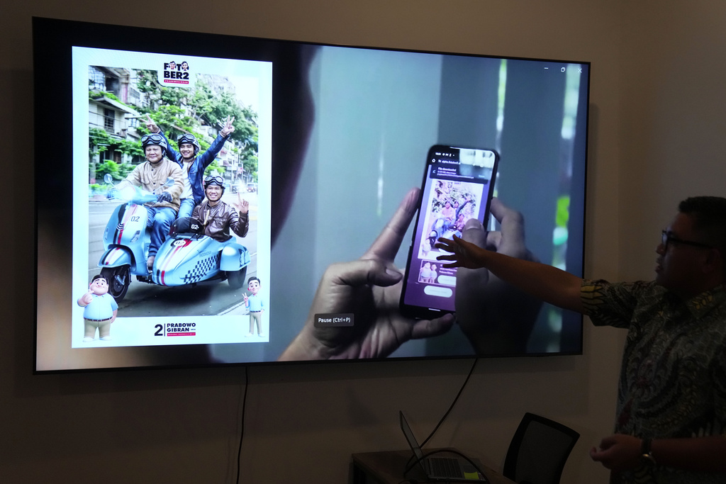 Noudhy Valdryno, the digital coordinator for the campaign team of Indonesian presidential frontrunner Prabowo Subianto, shows the interface of a web application  that allows supporters to upload photos to make AI-generated images of them with Subianto, in Jakarta, Indonesia, Wednesday, Feb. 21, 2024.