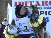 Dallas Seavey celebrates his win in the Iditarod Trail Sled Dog Race, Tuesday, March 12, 2024, in Nome, Alaska.