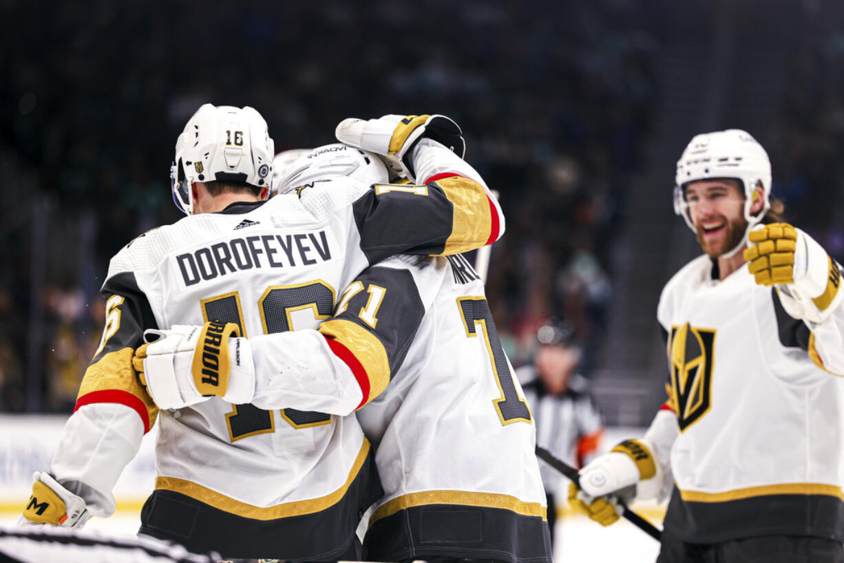 Vegas Golden Knights left wing Pavel Dorofeyev, left, celebrates after scoring a goal with center William Karlsson during the second period in an NHL hockey game against the Seattle Kraken Tuesday, March 12, 2024, in Seattle.