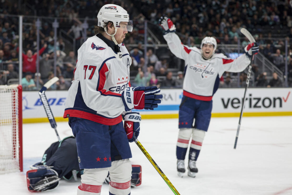 Washington Capitals right wing T.J. Oshie (77) and center Hendrix Lapierre react after Oshie's goal against Seattle Kraken goaltender Joey Daccord during the second period of an NHL hockey game Thursday, March 14, 2024, in Seattle.