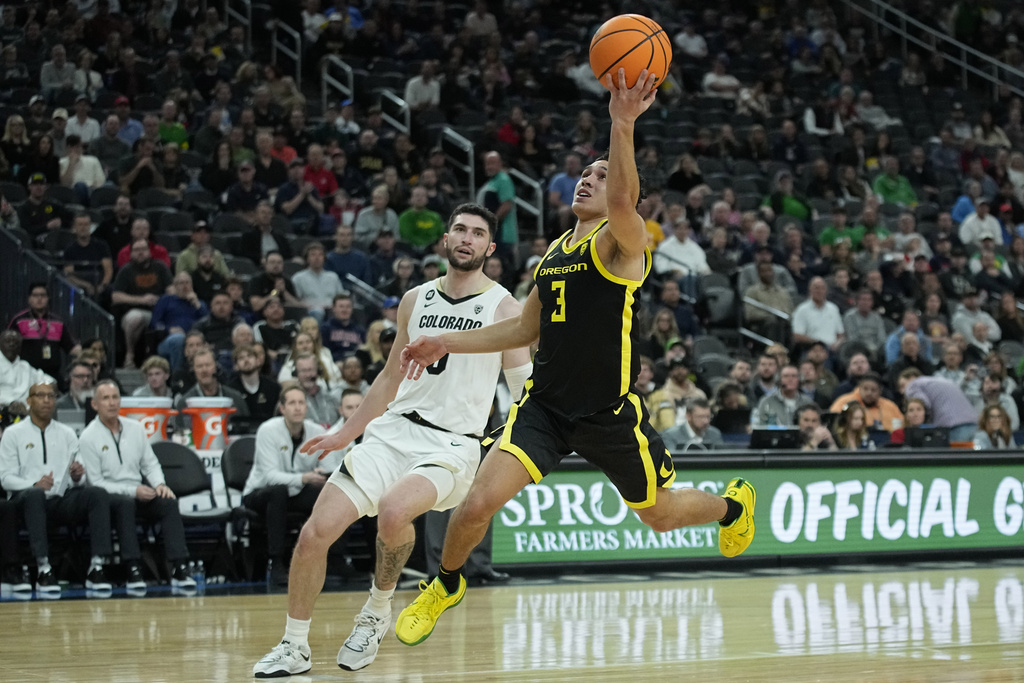 Oregon guard Jackson Shelstad (3) shoots over Colorado guard Luke O'Brien (0) during the first half of an NCAA college basketball game in the championship of the Pac-12 tournament Saturday, March 16, 2024, in Las Vegas.