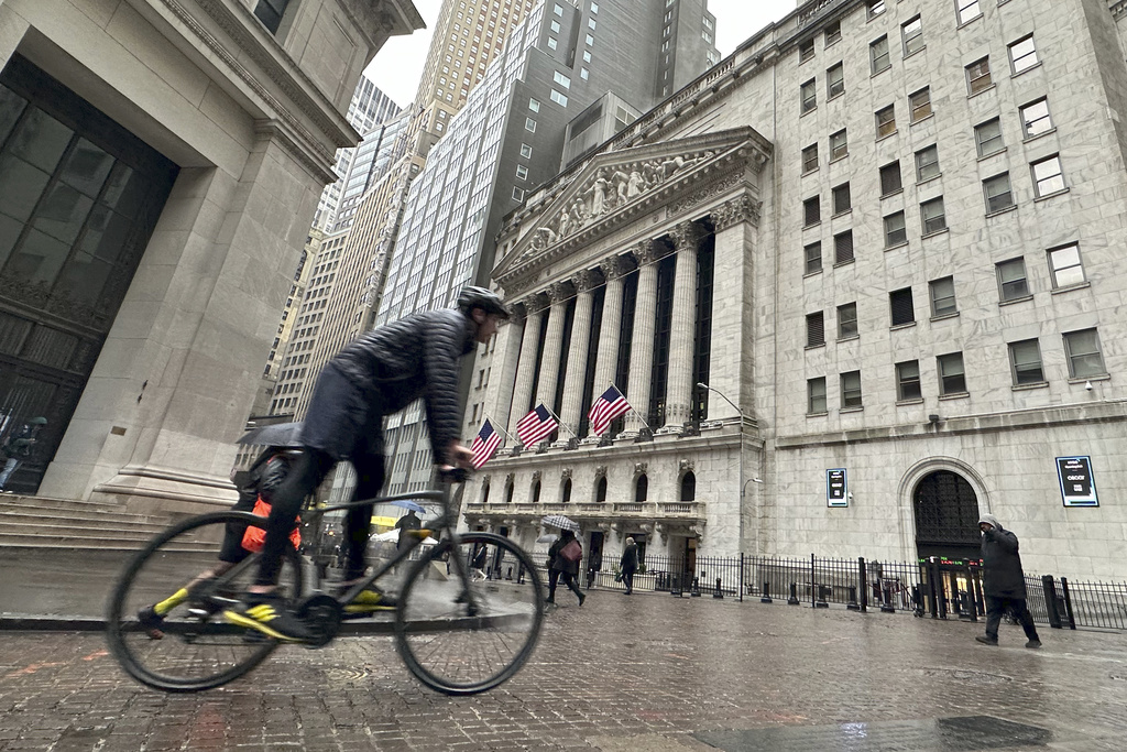 FILE - A bicyclist passes the New York Stock Exchange on March 5, 2024, in New York. Stocks are rising Monday, March 18, 2024 ahead of a busy week for central banks around the world that could dictate where interest rates go.The S&amp;P 500 was Tk% higher in early trading, coming off its first back-to-back weekly loss since October.