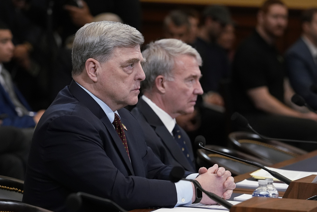 Retired Gen. Mark Milley, left, the former chairman of the Joint Chiefs of Staff, left, and retired Gen. Kenneth McKenzie, former commander of the U.S. Central Command, speak to the House Foreign Affairs Committee about the U.S. withdrawal from Afghanistan, at the Capitol in Washington, Tuesday, March 19, 2024. (AP Photo/J.