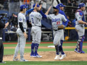 Los Angeles Dodgers designated hitter Shohei Ohtani, second from left, congratulates Teoscar Hernandez after the Dodgers defeated the San Diego Padres 5-2 in an opening day baseball game at the Gocheok Sky Dome in Seoul, South Korea Wednesday, March 20, 2024, in Seoul, South Korea.