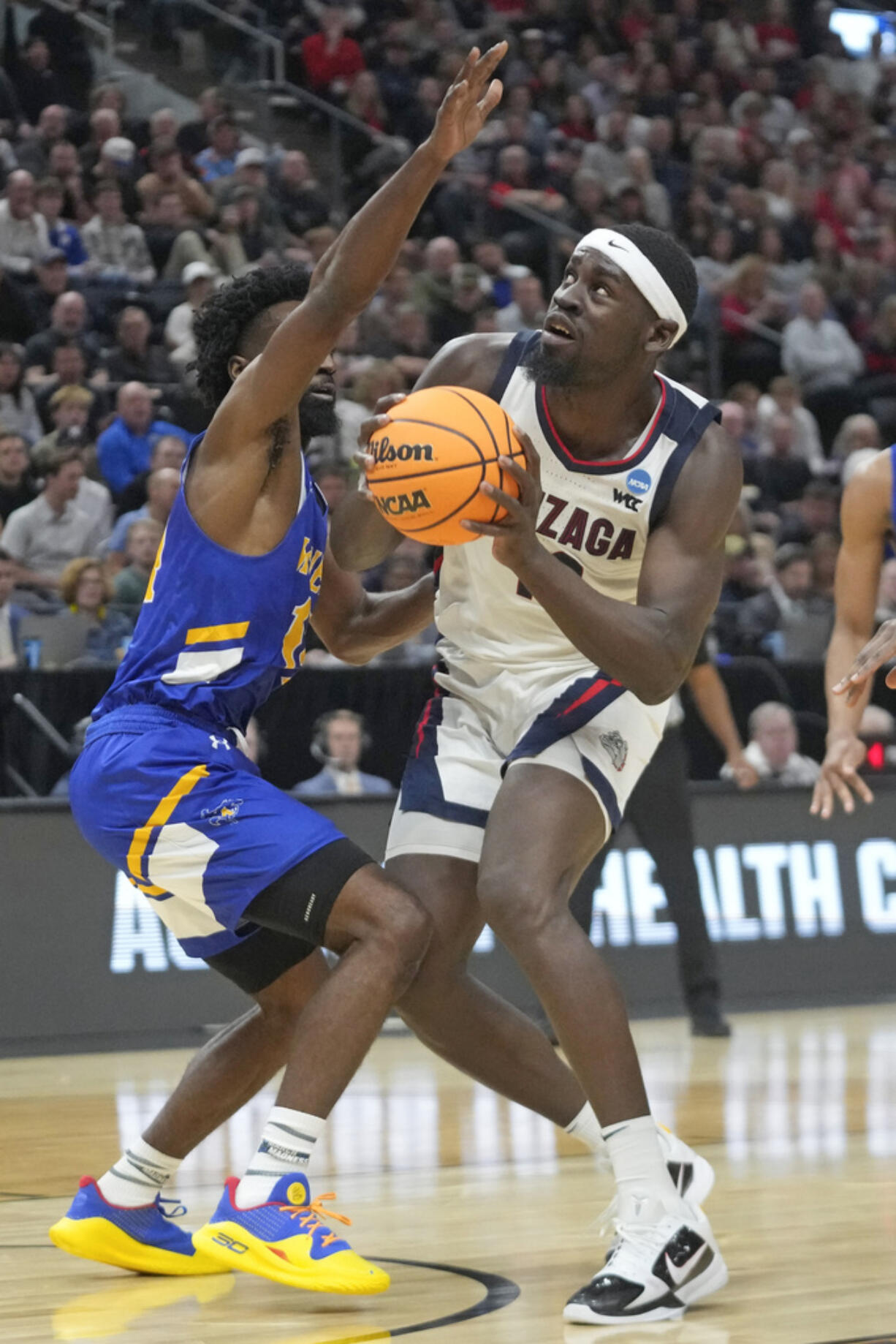 McNeese State guard Javohn Garcia, left, guards Gonzaga forward Graham Ike during the first half of a first-round college basketball game in the NCAA Tournament in Salt Lake City, Thursday, March 21, 2024.