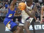 McNeese State guard Javohn Garcia, left, guards Gonzaga forward Graham Ike during the first half of a first-round college basketball game in the NCAA Tournament in Salt Lake City, Thursday, March 21, 2024.