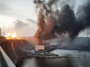 In this photo provided by Telegram Channel of Ukraine's Prime Minister Denys Shmyhal, smoke and fire rise over the Dnipro hydroelectric power plant after Russian attacks in Dnipro, Ukraine, Friday, March 22, 2024.