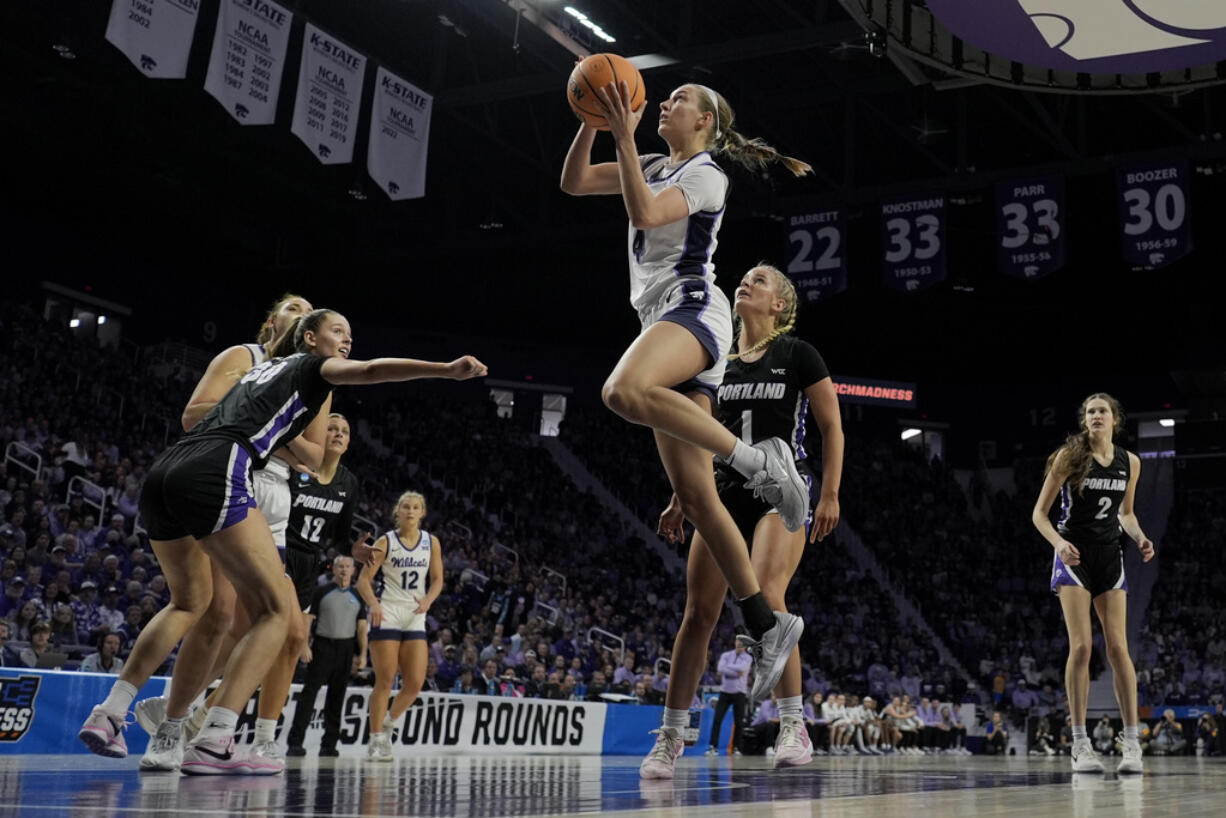 Kansas State guard Serena Sundell (4) gets past Portland guard McKelle Meek (1) to put up a shot during the first half of a first-round college basketball game in the women's NCAA Tournament in Manhattan, Kan., Friday, March 22, 2024, in Manhattan, Kan.