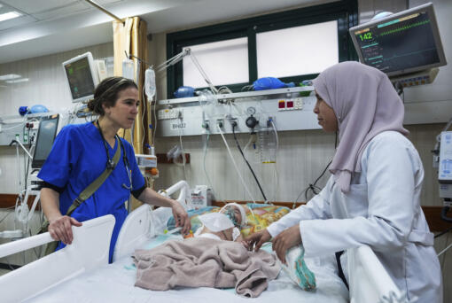 Pediatrician Tanya Haj-Hassan, left, examines wounded children at Al-Aqsa Martyrs Hospital in Deir al-Balah, central Gaza. Saturday, March 16, 2024.